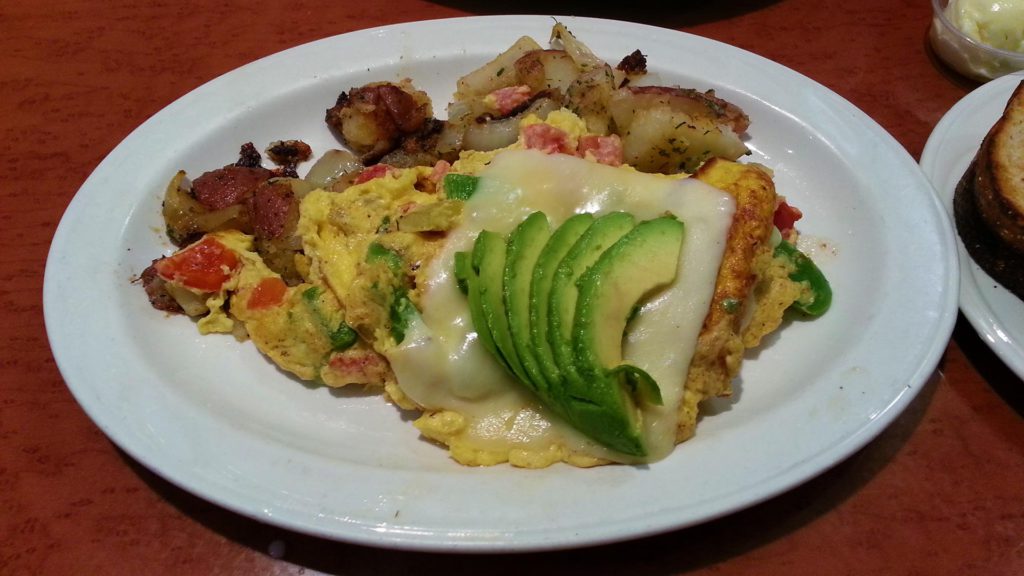 Omelette with avocado and breakfast potatoes