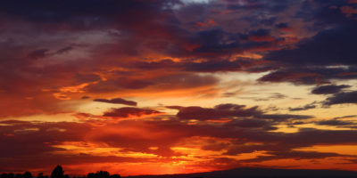 Colorful sunset with red, orange, yellow, blue, and purple hues.