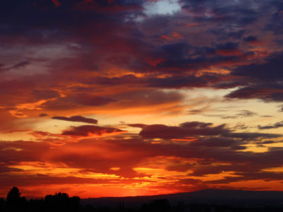 Colorful sunset with red, orange, yellow, blue, and purple hues.