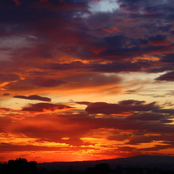 Colorful sunset with red, orange, yellow, blue, and purple hues.